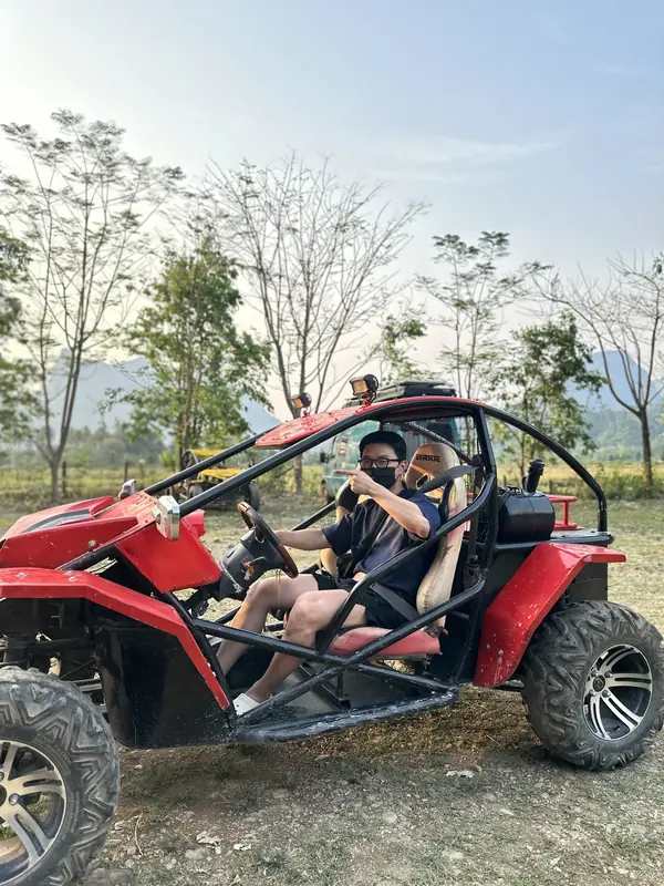 버기카 운전석에서 사진 찍는 자세를 잡는 친구