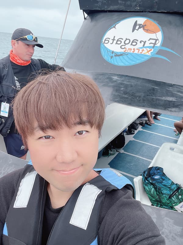 Blogger sitting on front of the boat to watch humpback whale