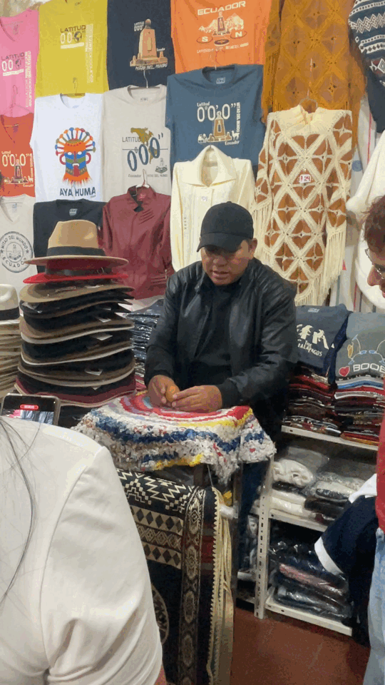 A shopkeeper putting up egg on the nail