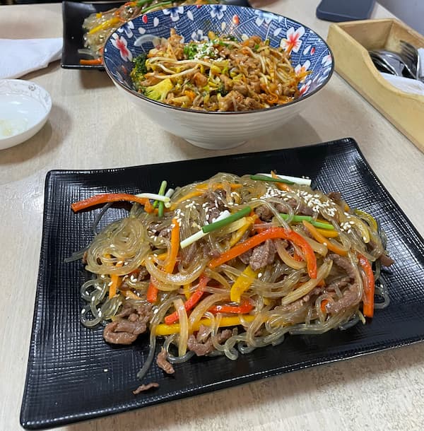 Japchae and rice with stir-fried pork